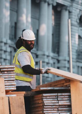 man in yellow and black stripe polo shirt and white cap sitting on brown wooden bench {{brizy_dc_image_alt imageSrc=
